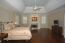 Spacious master bedroom with fireside sitting area and gleaming hardwood floors no image