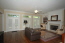 Spacious family room with a beautiful fireplace, built in bookcases, and three sets of french doors leading to the patio no image