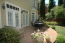 A welcoming, private outdoor living space with flower gardens and a water feature make this backyard special. no image