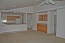 Kitchen and living room. Note built in cabinets to right no image